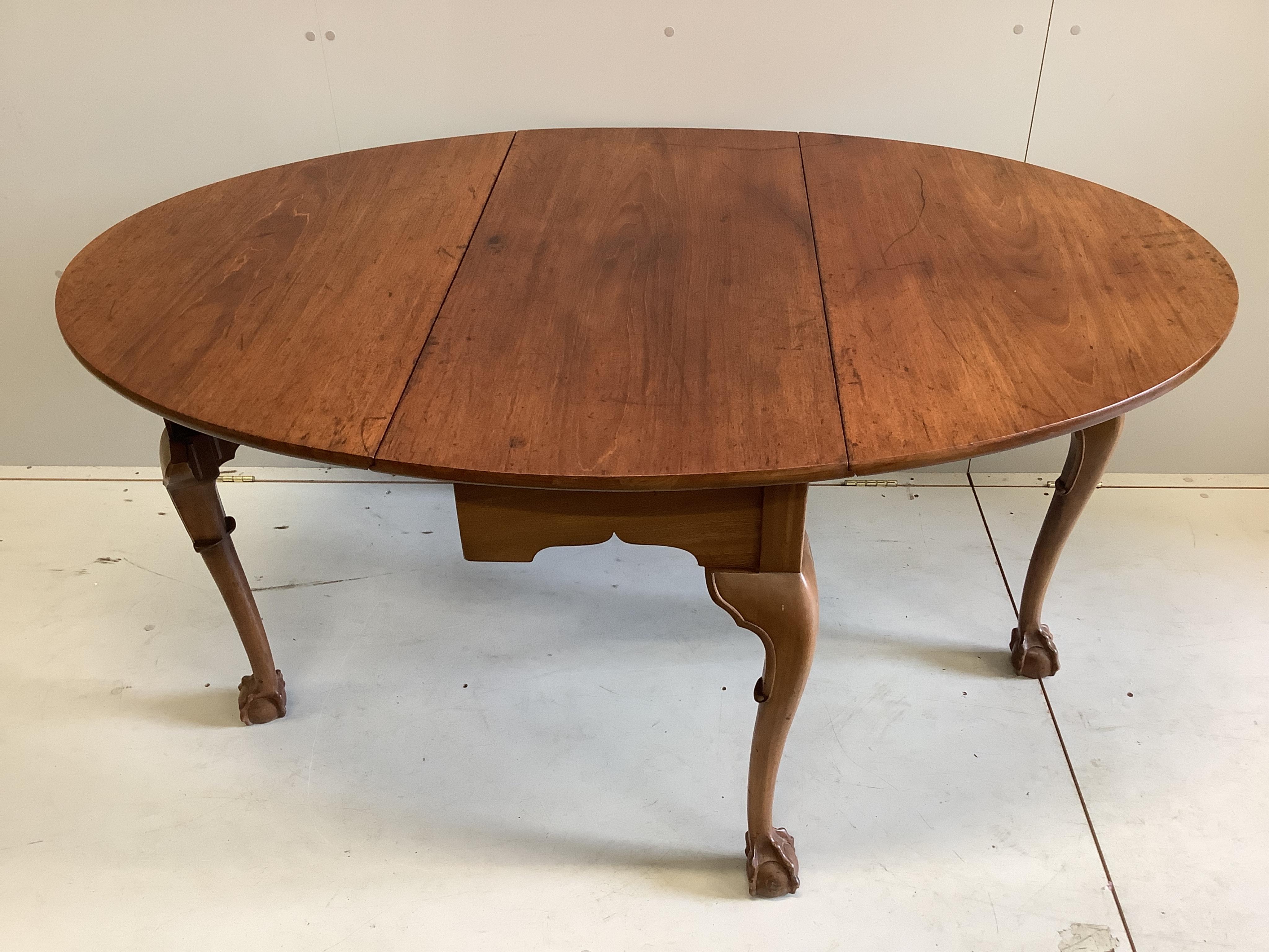 A George III style oval mahogany drop leaf dining table, 155cm extended, depth 106cm, height 74cm, together with a Regency style mahogany bowfront sideboard and six Hepplewhite style mahogany dining chairs. Condition - f